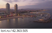 Scenic aerial panoramic view of modern Barcelona cityscape on Mediterranean coast with marina at summer twilight, Spain. Стоковое видео, видеограф Яков Филимонов / Фотобанк Лори