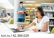 Young female hispanic student studying with a laptop. Стоковое фото, фотограф Яков Филимонов / Фотобанк Лори