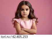 Serious funny little girl in pink dress arms crossed at pink backdrop, posing serious looking. Lovely kid lady coquette expressing emotion, studio shot. Child image emotion concept. Copy ad text space. Стоковое AI-изображение, AI-художник Aleksandr Golubev / Фотобанк Лори