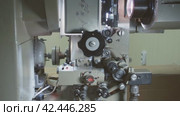 Old 35 mm movie projector working. The movement of the cine-film through the tape path. Стоковое видео, видеограф EStarodubov / Фотобанк Лори