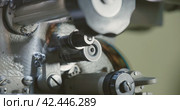 Tape drive mechanism of 35mm cine-film in movie projector. Film strip on vintage projector. Стоковое видео, видеограф EStarodubov / Фотобанк Лори