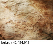Old parchment paper with illegible writing on it,    Generative AI. Стоковое AI-изображение, AI-художник Анна Кривицкая / Фотобанк Лори