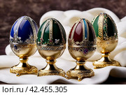 Russian jewelry souvenir, easter eggs copy of Faberge, unique impressive collection of jewelry, made by famous russian jewelers. Copy space. Стоковое AI-изображение, AI-художник Aleksandr Golubev / Фотобанк Лори