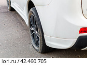Car have a flat tire. Close up shot of vehicle with damaged wheel. Стоковое фото, фотограф Константин Григорьев / Фотобанк Лори