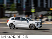 Haval Jolion rides on the road. White compact crossover SUV on the city street in motion. Редакционное фото, фотограф Константин Григорьев / Фотобанк Лори
