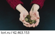 Ten-ruble coins are poured into the hands of a pensioner, the concept of poverty. Стоковое видео, видеограф Корнеев Вячеслав / Фотобанк Лори