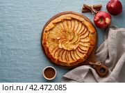 Apple pie, galette with fruits, sweet pastries on blue linen, copy space, top view. Стоковое фото, фотограф Natalia Gdovskaia / Фотобанк Лори
