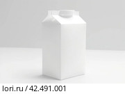 Blank milk package box on grey box. Generate Ai. Стоковое AI-изображение, AI-художник Иван Рябоконь / Фотобанк Лори