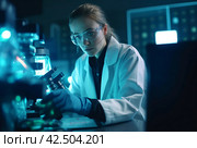 Concentrated female microbiologist in laboratory. Generate Ai. Стоковое AI-изображение, AI-художник Иван Рябоконь / Фотобанк Лори