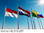 Flags different countries on high flagpoles. National flag different fluttering in wind. Flag Korea, Russia, United States, India, Vietnam, Cambodia and other against blue sky. Natural vertical photo. Стоковое AI-изображение, AI-художник Aleksandr Golubev / Фотобанк Лори