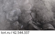 Movement of the knocked-out molding mixture with castings along the conveyor. Стоковое видео, видеограф Татьяна Яцевич / Фотобанк Лори