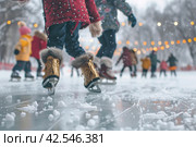 Little girl in ice skates learning how to keep her balance on the ice rink. Стоковое AI-изображение, AI-художник Юрий Поздников / Фотобанк Лори