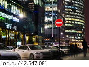 Prohibitory sign for directions. No Entry road-sign mounted on metal pole. Night view of financial district in the city. Стоковое фото, фотограф Константин Григорьев / Фотобанк Лори