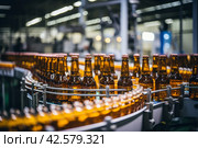 Brown glass beer bottles on brewery conveyor, modern production line for alcohol beverage manufacturing. Стоковое AI-изображение, AI-художник Светлана Акифьева / Фотобанк Лори