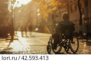 Side view of a disabled man in a wheelchair, on a city street, beautiful sunlight. Стоковое AI-изображение, AI-художник Ярославский Максим / Фотобанк Лори
