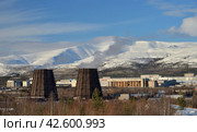 Apatity, Murmansk region, Russia, March 12, 2024: Territory of industrial area of Second apatite-nepheline concentration factory in north of city at foot of Vudyavrchorr Khibin mountain. Редакционное фото, фотограф Алексей Антипов / Фотобанк Лори