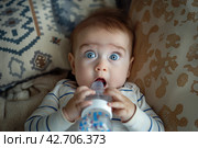 Surprised Baby with Bottle. Стоковое AI-изображение, AI-художник Кирилл Черезов / Фотобанк Лори
