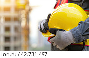 Engineer team hold hardhat, safety helmet, for safety teamwor. Стоковое AI-изображение, AI-художник Ярославский Максим / Фотобанк Лори