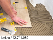 The process of laying floor tiles on the SVP Base, Tile Leveling System. Стоковое фото, фотограф Evgenii Predibailo / Фотобанк Лори
