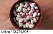 Cranberry beans spinning. Borlotti bean pods in wooden bowl. Top view. Stylish modern food background. Magenta color. Creative foodstuff flat lay. Grocery, dietary backdrop. Advertising, trendy video. Стоковое видео, видеограф Марина Демидюк / Фотобанк Лори