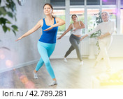 Happy woman training vigorous zumba in fitness studio. Стоковое фото, фотограф Яков Филимонов / Фотобанк Лори