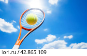 tennis racket in his hand against blue sky. Стоковое AI-изображение, AI-художник ALLA YURTAYEVA / Фотобанк Лори