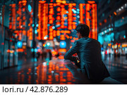 A man in a business suit looks thoughtfully at the busy streets of the city with bright neon lighting. This image is full of atmosphere and can be interpreted as a moment of reflection on life's journey or as a break from the fast pace of modern life. Стоковое AI-изображение, AI-художник Анна Кривицкая / Фотобанк Лори