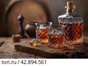 Two glasses and bottle of whiskey on a wooden table, Стоковое AI-изображение, AI-художник Анна Кривицкая / Фотобанк Лори