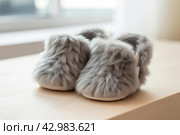 Worn Pair of grey slippers on floor. Generate Ai. Стоковое AI-изображение, AI-художник Иван Рябоконь / Фотобанк Лори