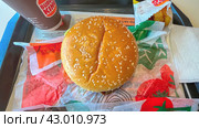 Moscow April 10 2024, Big burger with two patties on a tray in burger king. Burger on a tray in fast food restaurant close-up. Fast food restaurant and self-service checkouts. Редакционное фото, фотограф Скрипачев Антон / Фотобанк Лори
