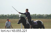 Samara, Russia - August 29, 2019: Horseman Kozak on a horse cuts a cavalry saber a plastic bottle of water. Slow motion. Редакционное видео, видеограф Александр Прошкин / Фотобанк Лори