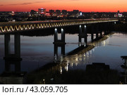 Метромост в ночной подсветке отражается в реке Оке, Нижний Новгород, ночной город на фоне заката. Редакционное фото, фотограф Андрей В. Карпов / Фотобанк Лори