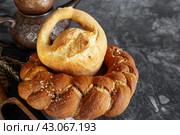 Assortment of white bread. Kalach and challah made of wheat flour on table with milk. Copy space. Стоковое фото, фотограф Оксана Медведева / Фотобанк Лори