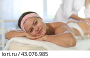 Young woman enjoying deep tissue massage of thighs and buttocks to get rid of cellulite and improve lymphatic drainage in spa center. Стоковое видео, видеограф Яков Филимонов / Фотобанк Лори