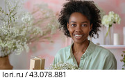 Radiant Woman with Flowers and Gift in Springtime Setting, ai-generated item. Стоковое AI-изображение, AI-художник Юлия Паутова / Фотобанк Лори
