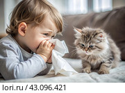 A small child boy sneezes into a white napkin at home. Allergies to cats and pet hair. A kitten is sitting next to me. Стоковое AI-изображение, AI-художник Photojuli / Фотобанк Лори