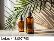 Aromatherapy. A glass bottle with a pipette for oil, lotion and palm leaves on a concrete background. Natural organic eco-cosmetics. The layout of the corporate identity of the beauty salon. Стоковое AI-изображение, AI-художник Photojuli / Фотобанк Лори