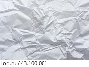 Белая мятая оберточная бумага в качестве абстрактного фона, текстуры.  Crumpled white wrapping paper as abstract background, texture. Стоковое фото, фотограф Лариса Гордеева / Фотобанк Лори