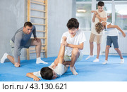 Teens practicing armlock in training bout during self defence course. Стоковое фото, фотограф Яков Филимонов / Фотобанк Лори