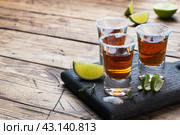 Glass with alcohol, salt and lime on a wooden background. Cognac whiskey tequila. The concept of the party. Selective focus Copy space. Стоковое фото, фотограф Глущенко Елена / Фотобанк Лори