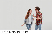 A young couple is fighting emotionally. White background, isolated. Стоковое AI-изображение, AI-художник Ярославский Максим / Фотобанк Лори
