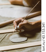 Woman making pattern on ceramic plate, drawing. Creative hobby concept. Earn extra money. Стоковое фото, фотограф Natalia Gdovskaia / Фотобанк Лори