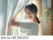 Young asian woman unveil curtain and looking out of window in the morning. Beautiful girl nearly window after waking up fully rested and open curtains. Start the new day with happiness. Relax, resting. Стоковое AI-изображение, AI-художник Марина Демидюк / Фотобанк Лори