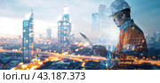 Silhouette of a construction worker in a hard hat against the background of a night city. Double exposure. A banner for the site. Стоковое AI-изображение, AI-художник Ярославский Максим / Фотобанк Лори