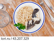 Tender meat of baked cod fillet is garnished with boiled basmati rice. Стоковое фото, фотограф Яков Филимонов / Фотобанк Лори