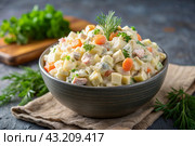 Traditional Russian Olivier salad for a feast on a plate on a wooden countertop. generative AI. Стоковое AI-изображение, AI-художник Photojuli / Фотобанк Лори