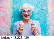 Portrait of an extraordinary, stylish, fashionable elderly woman, a pensioner of 70 years old, with glasses and ice cream in her hand. The concept of happy seniors and delicious desserts. Стоковое AI-изображение, AI-художник Photojuli / Фотобанк Лори