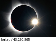 Glowing orange annular solar eclipse with black background and ring of fire. Стоковое AI-изображение, AI-художник Анна Маркина / Фотобанк Лори
