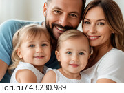 Mom and dad with two small children, close-up. Family portrait, the concept of family relations. The program of state support for families with children. Стоковое AI-изображение, AI-художник Анна Маркина / Фотобанк Лори