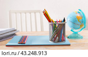 Closeup of color pencils, wax chalks, globe and notebooks. Стоковое фото, фотограф Яков Филимонов / Фотобанк Лори